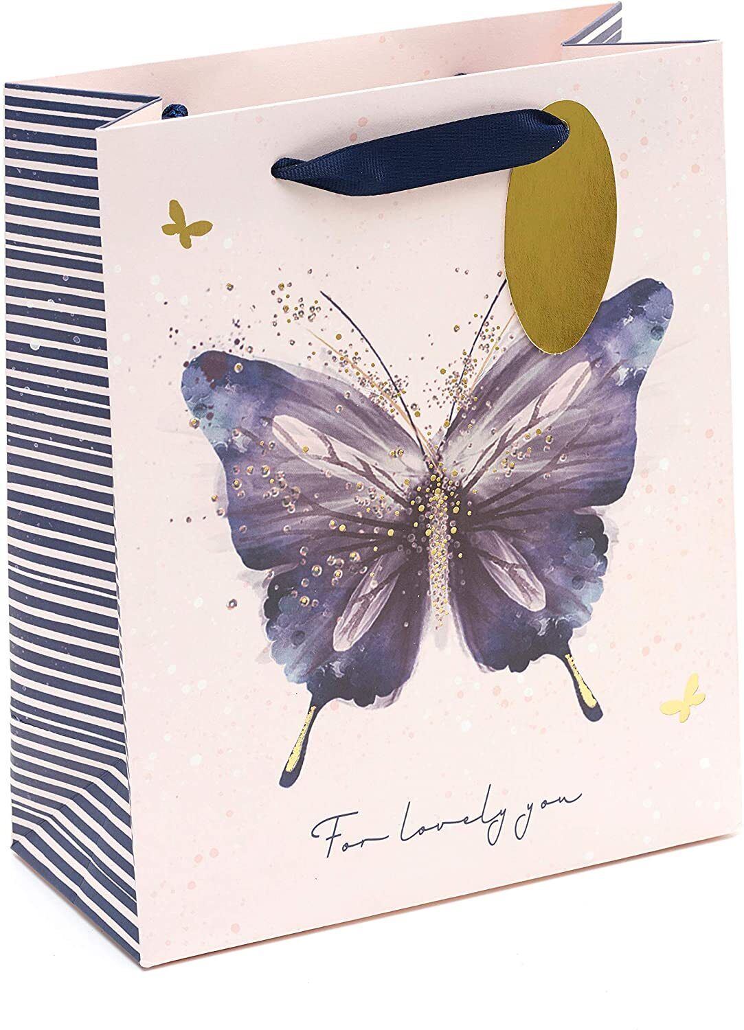 UK Greetings pink and purple butterfly design medium gift bag with handles, featuring floral accents and decorative patterns.