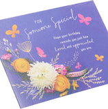 UK Greetings elegant blue and floral birthday greeting card, blank inside for personal message, featuring detailed floral design.