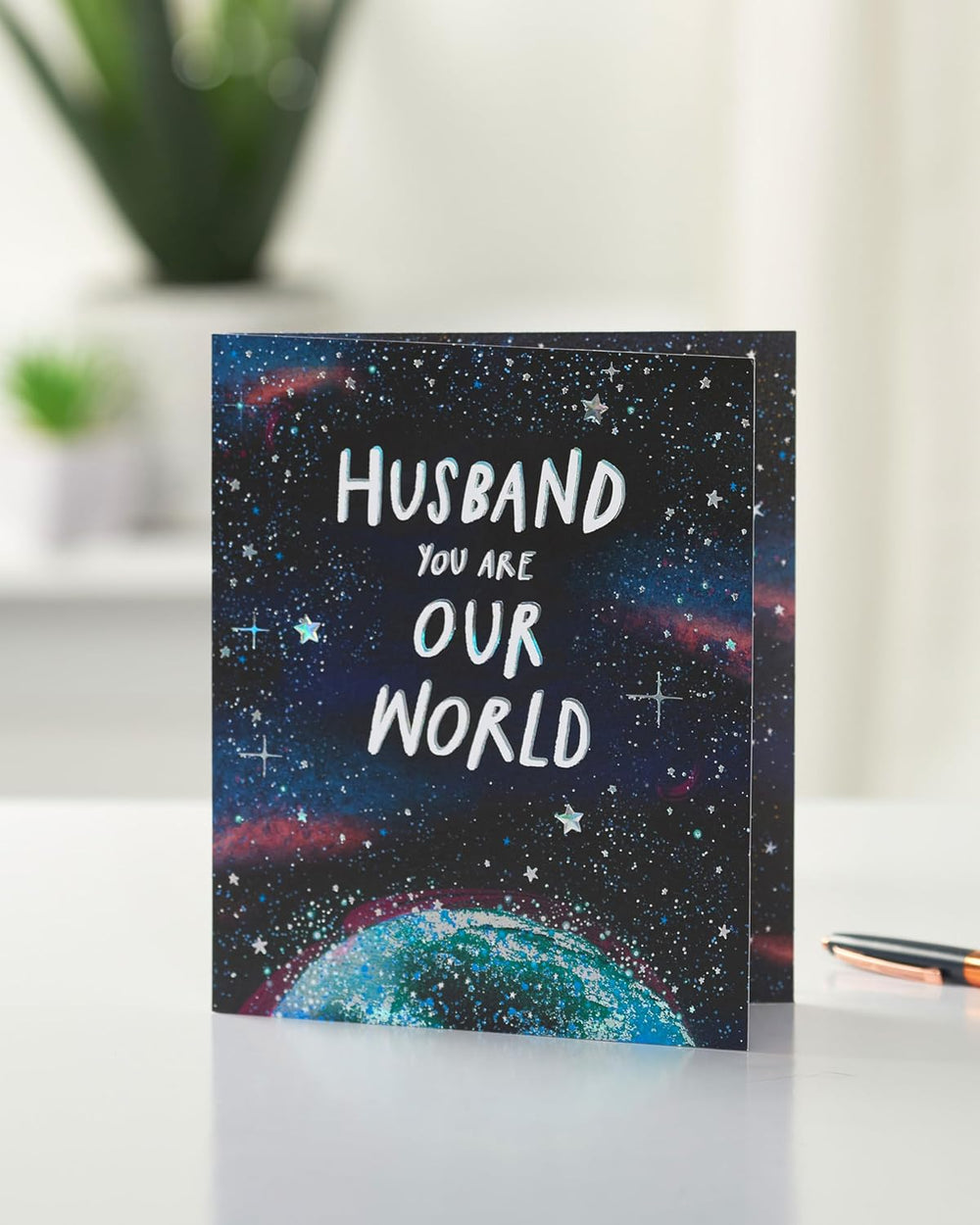 UK Greetings Father's Day card for husband featuring Our World design, with colorful illustrations and heartfelt message inside.