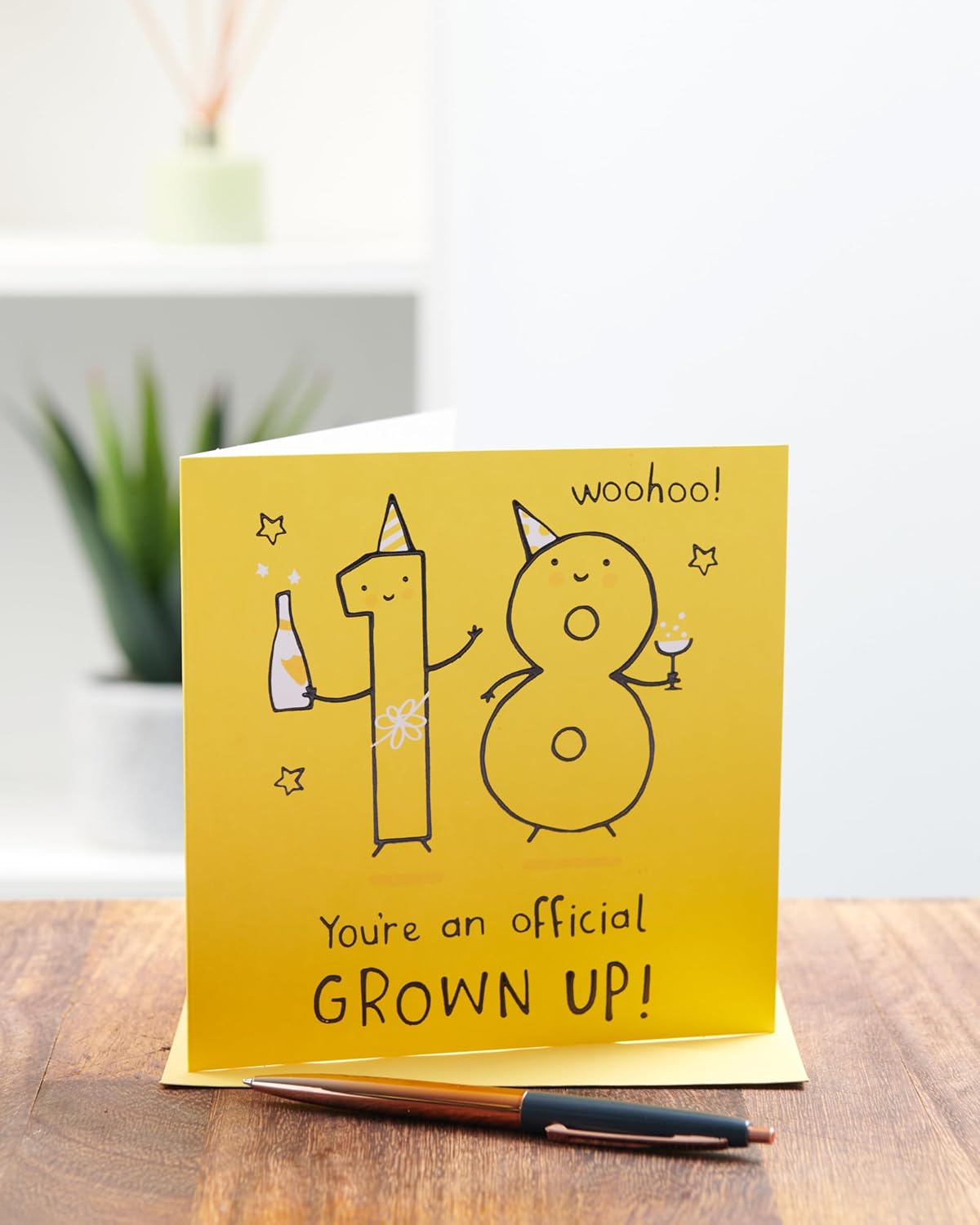 UK Greetings 18th birthday greeting card for him, her, or friends featuring a bright yellow design and cheerful message.