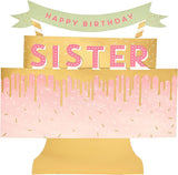 UK Greetings 3D pop-up sister birthday card featuring a colorful cake design, perfect for celebrating with loved ones.
