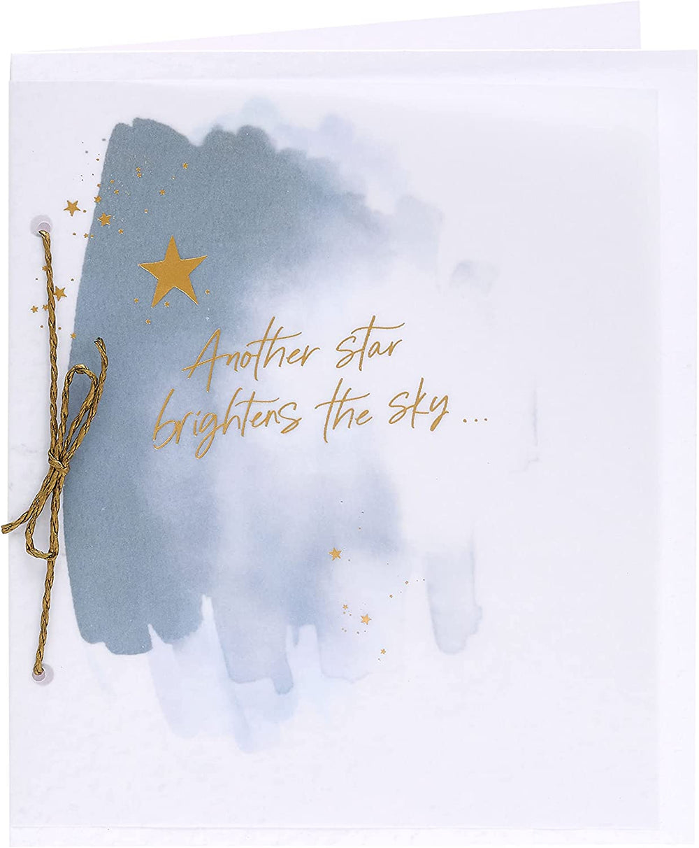 UK Greetings sympathy card featuring a gold foil starry sky design, conveying heartfelt condolences in a thoughtful greeting card.