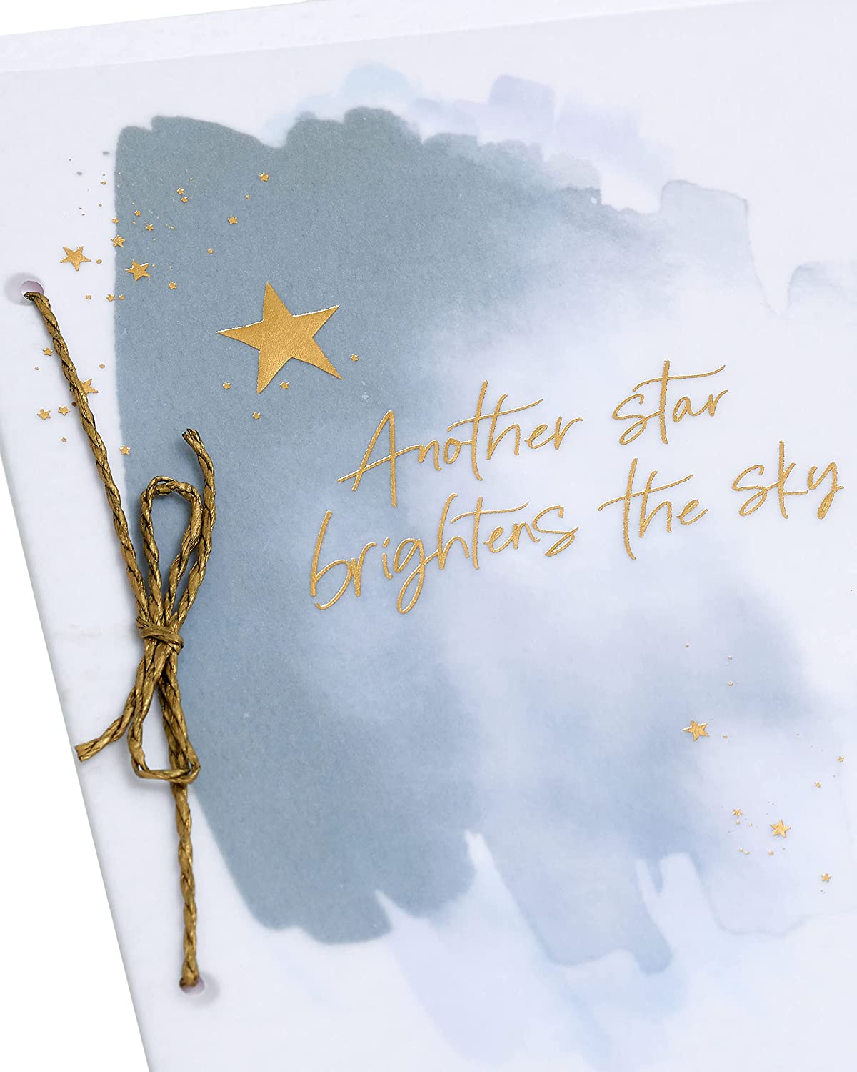 UK Greetings sympathy greeting card featuring a gold foil star and bright sky design, conveying heartfelt condolences.