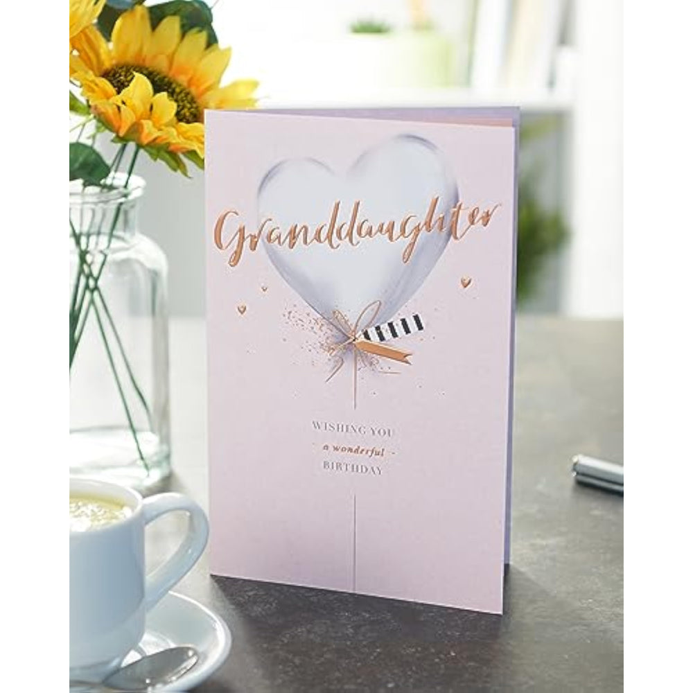 UK Greetings birthday card for granddaughter with silver balloon design, featuring colorful balloons and festive greeting.