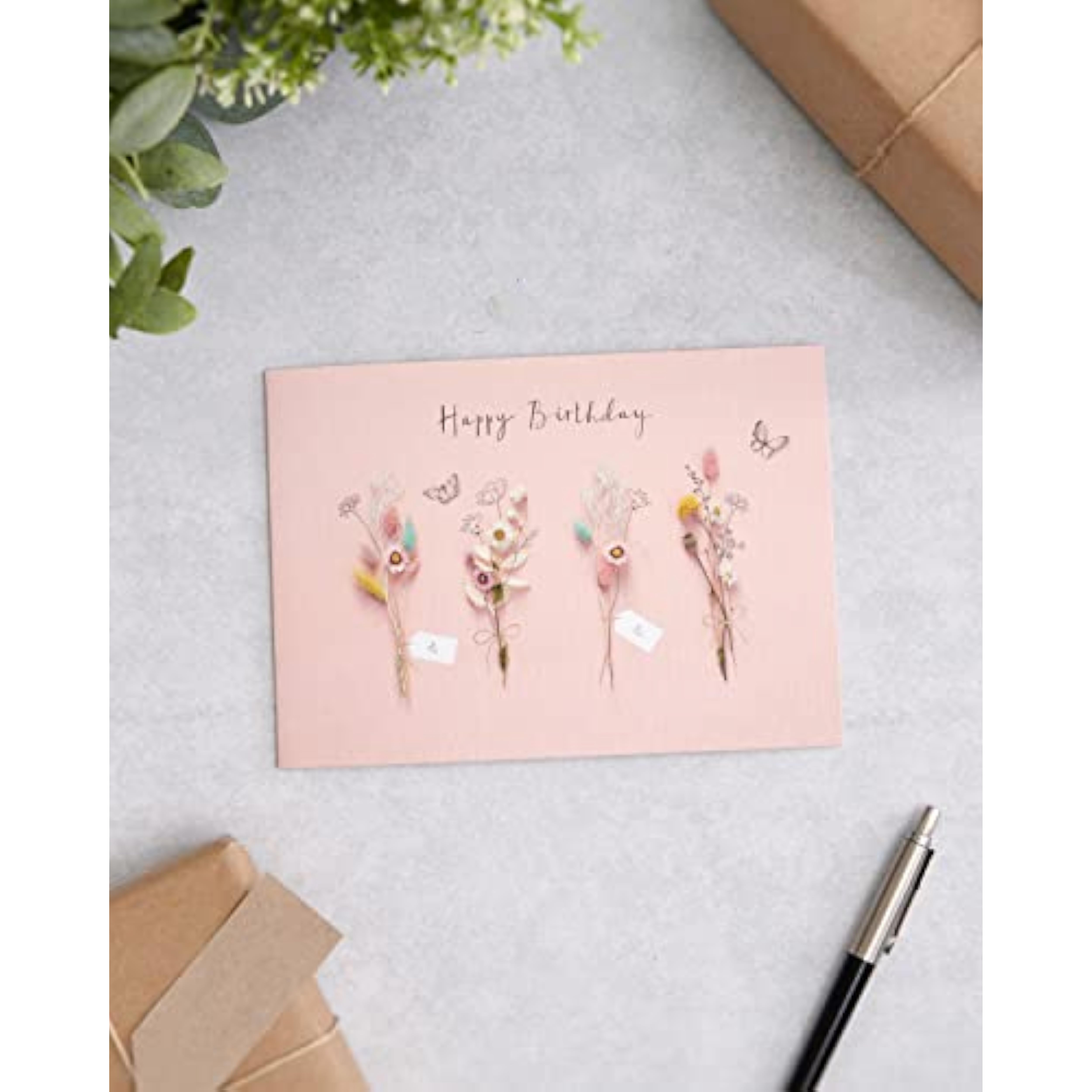 UK Greetings birthday card for her featuring dried flower design, includes envelope, ideal for female friends.