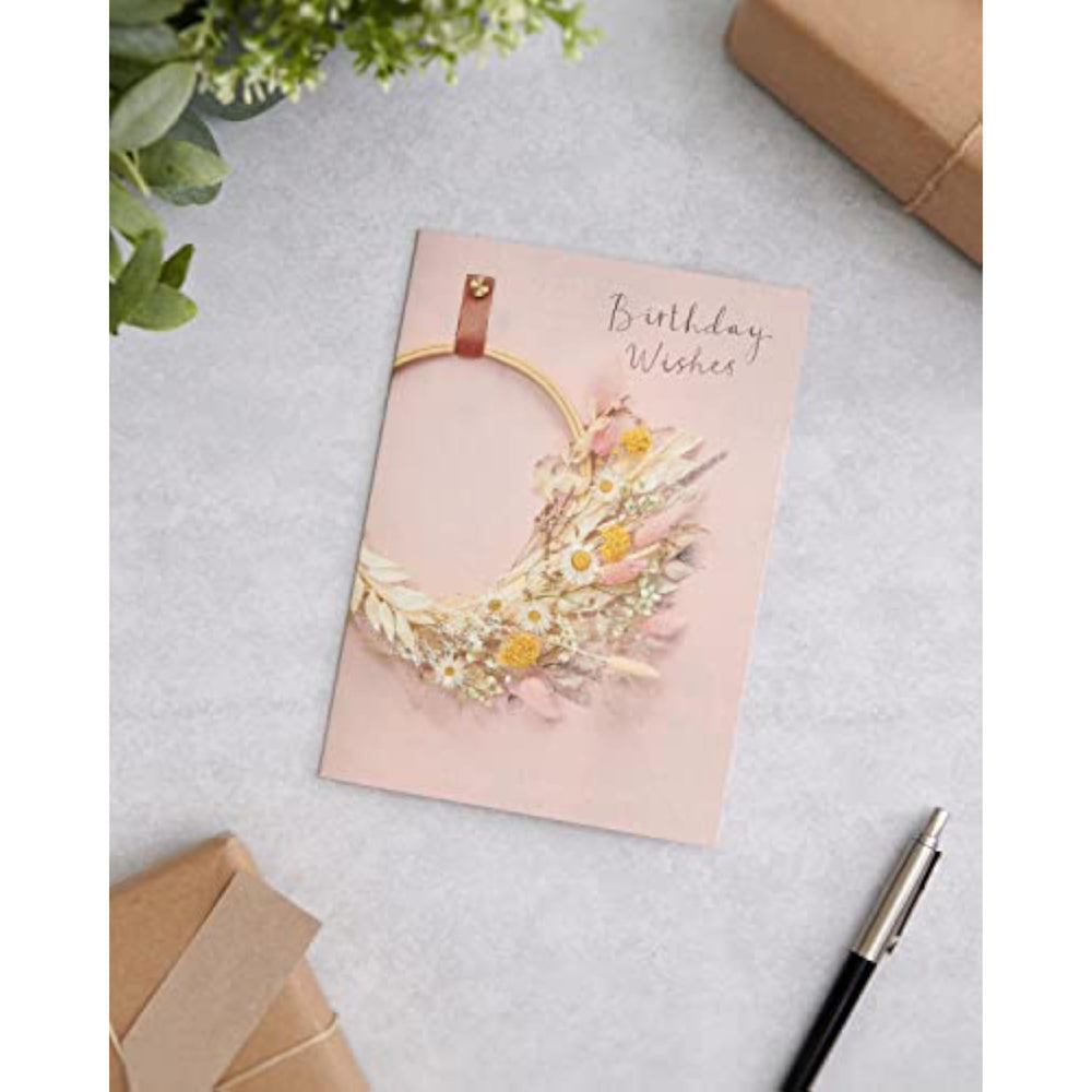 UK Greetings birthday card for her featuring a floral hoop design, includes envelope, perfect for female friends.
