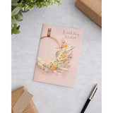 UK Greetings birthday card for her featuring a floral hoop design, includes envelope, perfect for female friends.