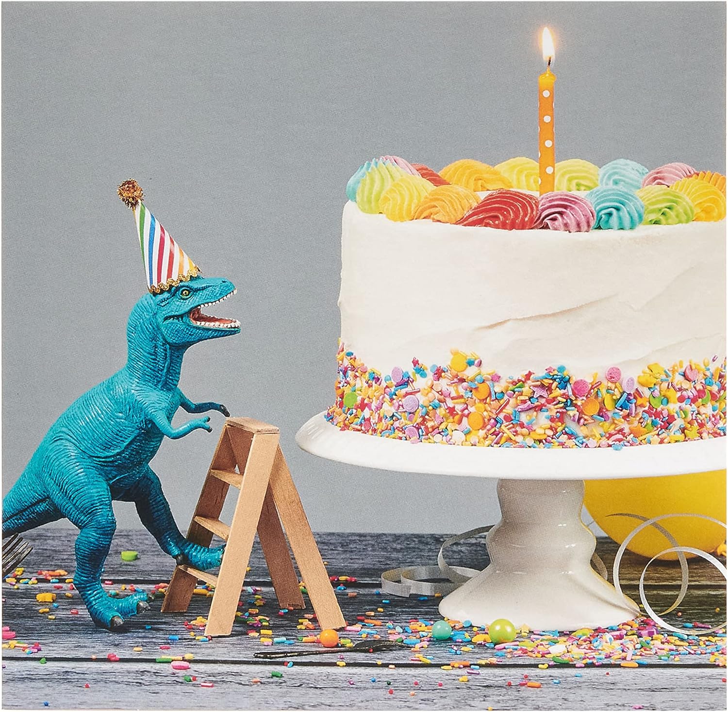 UK Greetings birthday card for him and friend featuring colorful cake and dinosaur design, ideal for celebrating special occasions.