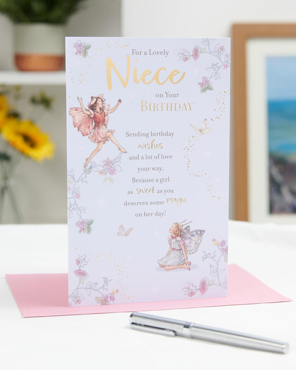 UK Greetings birthday card for niece featuring a whimsical fairies design, with colorful fairy illustrations on the front.