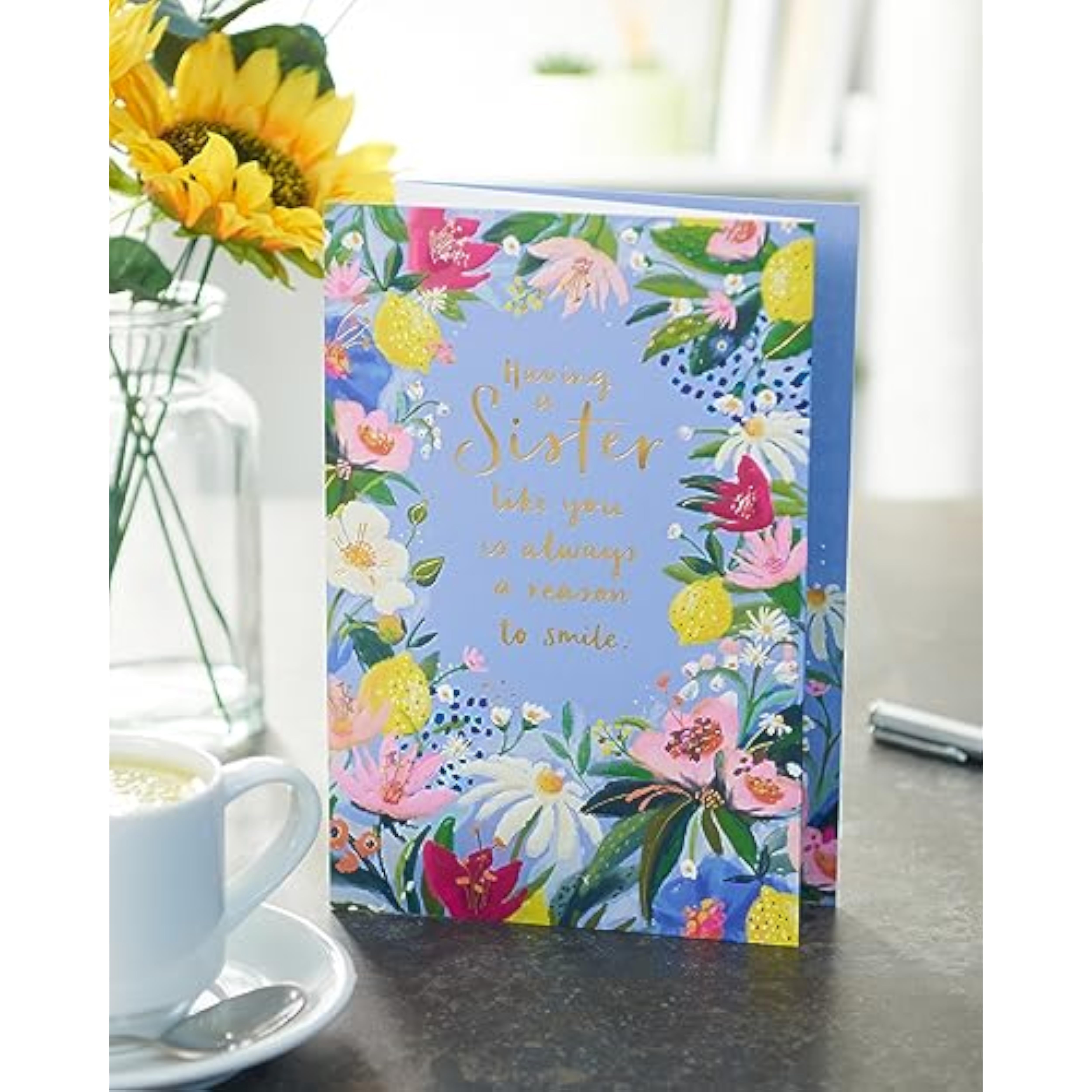 UK Greetings birthday card for sister with floral border design, featuring colorful flowers and heartfelt message inside.
