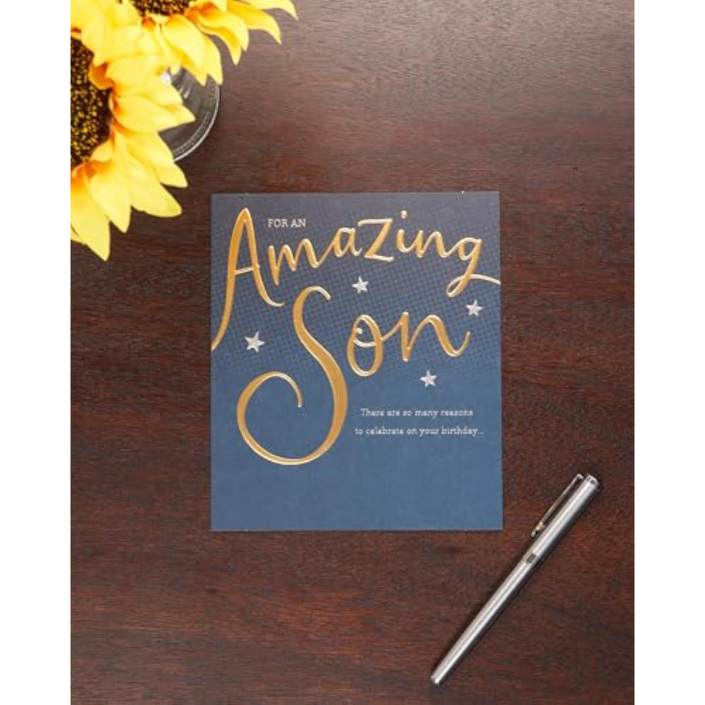 UK Greetings birthday card for son featuring a gold and blue design, showcasing vibrant colors and festive details.