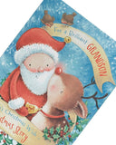 UK Greetings Christmas greeting card featuring Rudolph, Santa, and a storybook design, perfect for celebrating with a grandson.