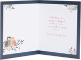 UK Greetings Christmas card featuring festive owls, designed for Aunt and Uncle, with colorful holiday-themed illustrations.