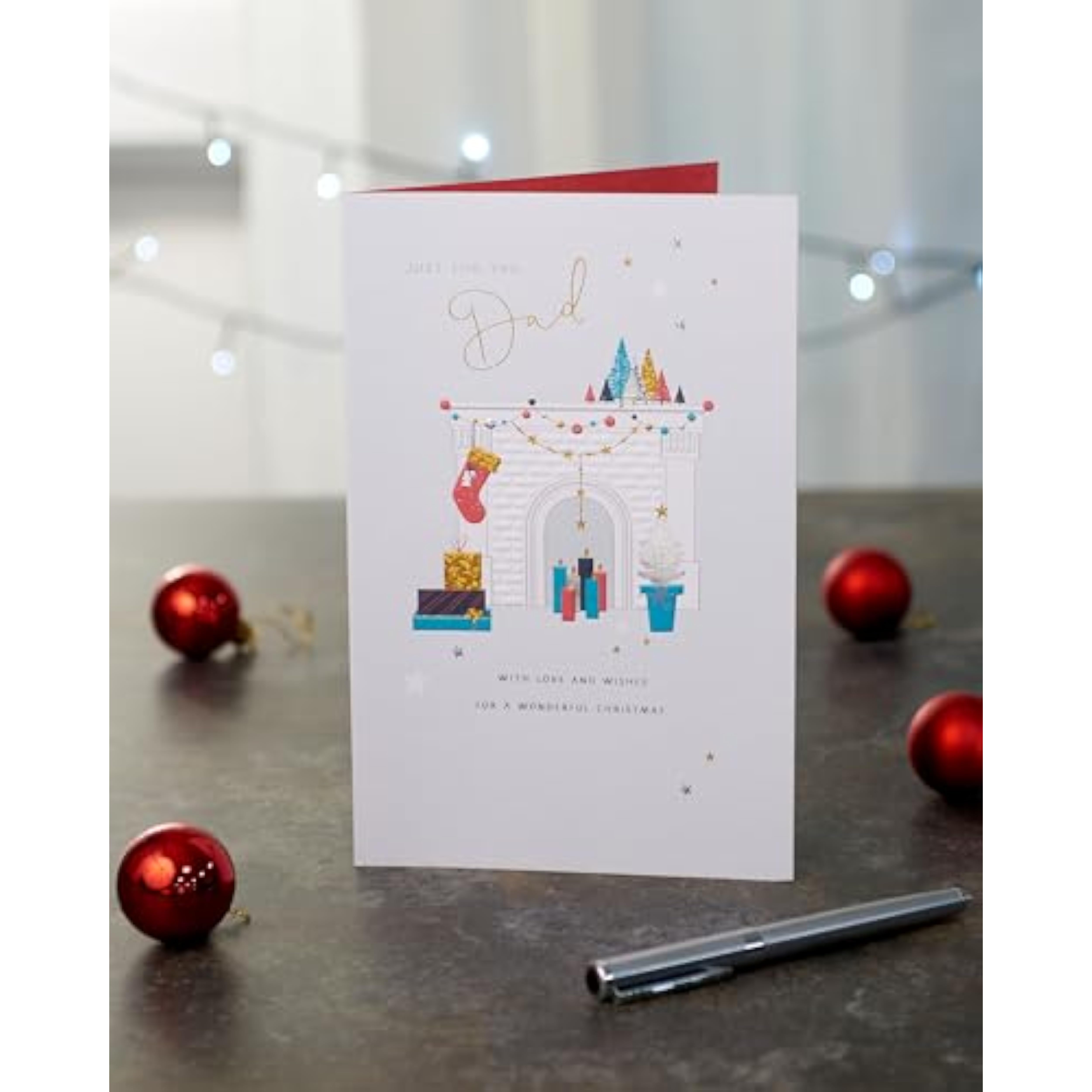 UK Greetings Christmas card for Dad featuring a decorated fireplace design, with festive holiday elements on a 149 x 229 mm card.