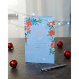 UK Greetings Christmas card for her or a friend featuring a floral design, perfect for holiday greetings and festive wishes.