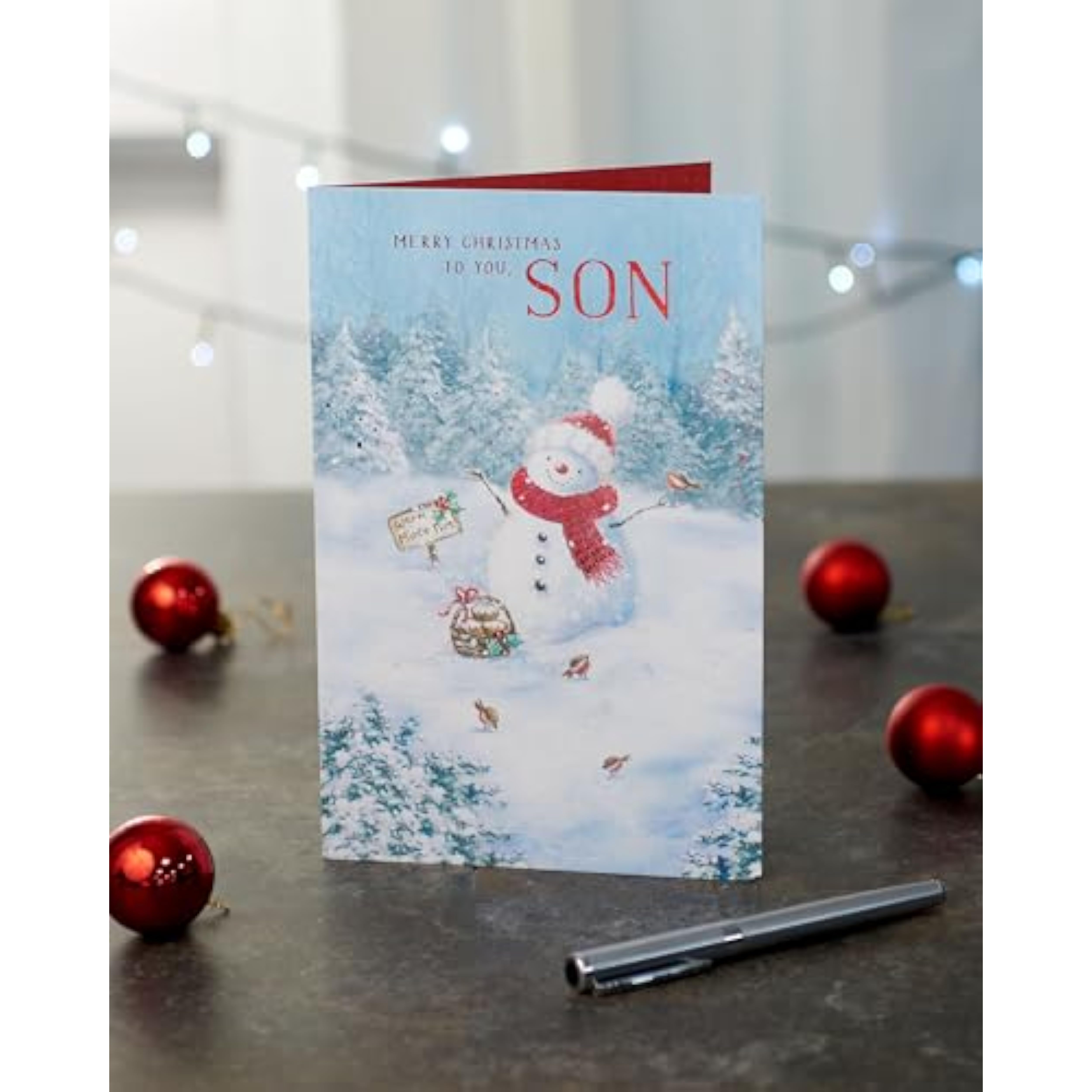 UK Greetings Christmas card for son featuring a festive snowman design, perfect for holiday greetings and seasonal cheer.