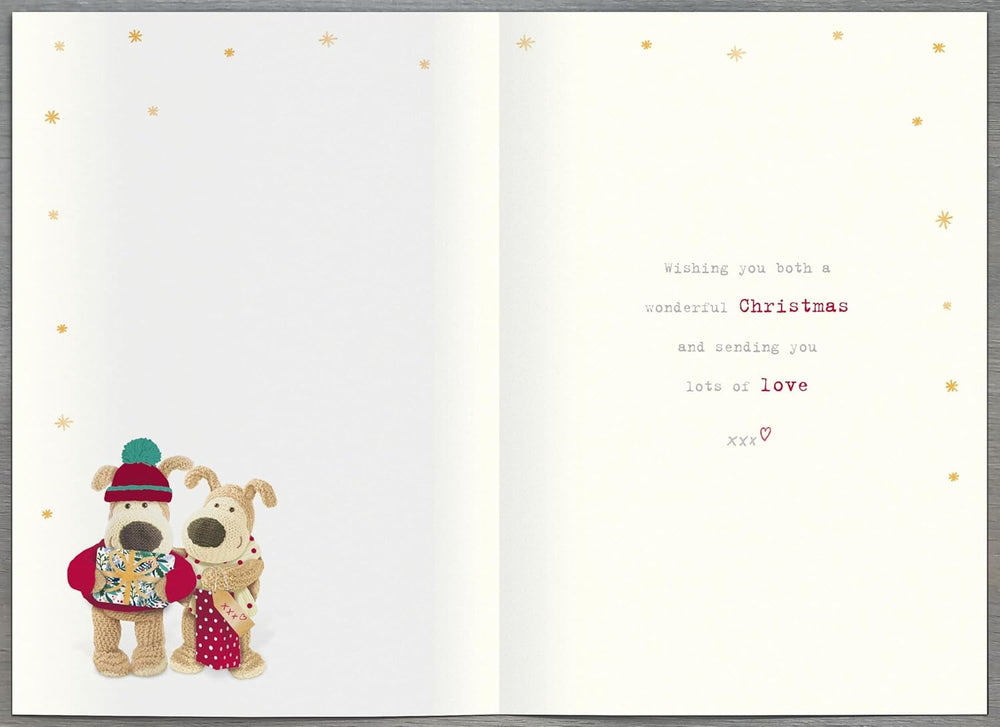 UK Greetings Christmas greeting card featuring cute Boofle holding gifts, with festive design for daughter and partner.