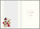 UK Greetings Christmas greeting card featuring cute Boofle holding gifts, with festive design for daughter and partner.