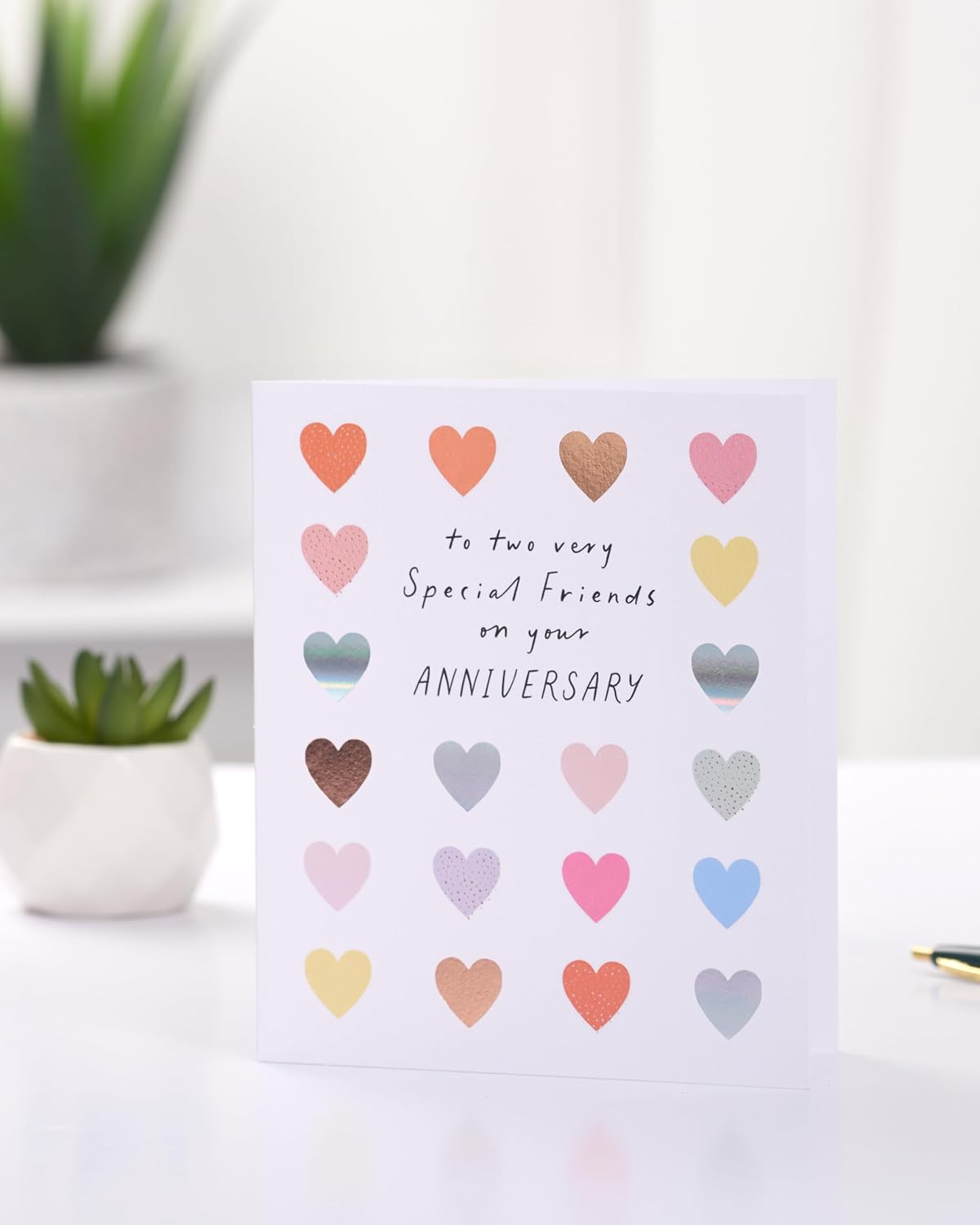 UK Greetings colorful hearts anniversary greeting card for friends, featuring bright and loving design for special occasions.