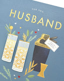 UK Greetings contemporary cocktail design birthday card for husband, featuring vibrant colors and stylish illustration.