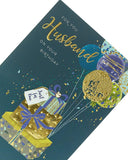 UK Greetings contemporary husband birthday card with colorful balloons attached to gift boxes, perfect for celebrating special occasions.