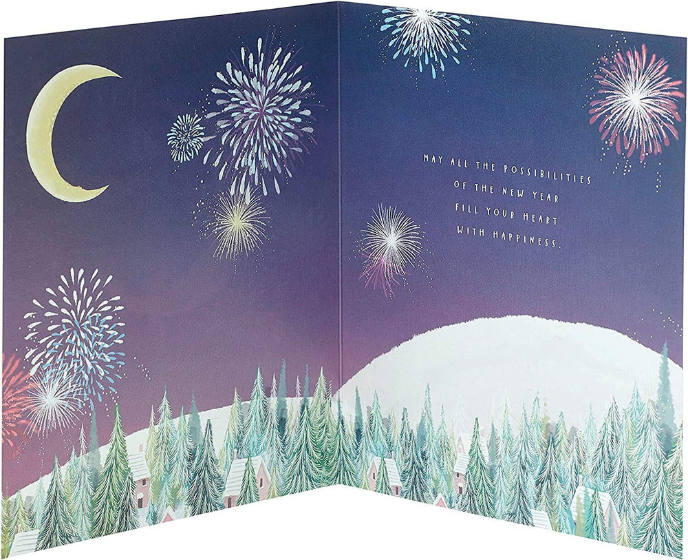 UK Greetings couple sitting on a half moon New Year Christmas card featuring festive winter scenery and holiday greetings.