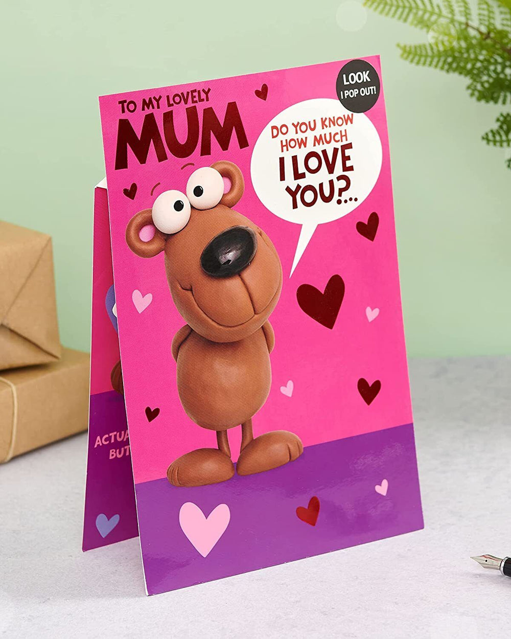 UK Greetings birthday card featuring a cute message inside for Mum, with colorful floral design and cheerful illustration.