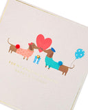 UK Greetings birthday card featuring a cute sausage dog design, perfect for celebrating your husband's special day.