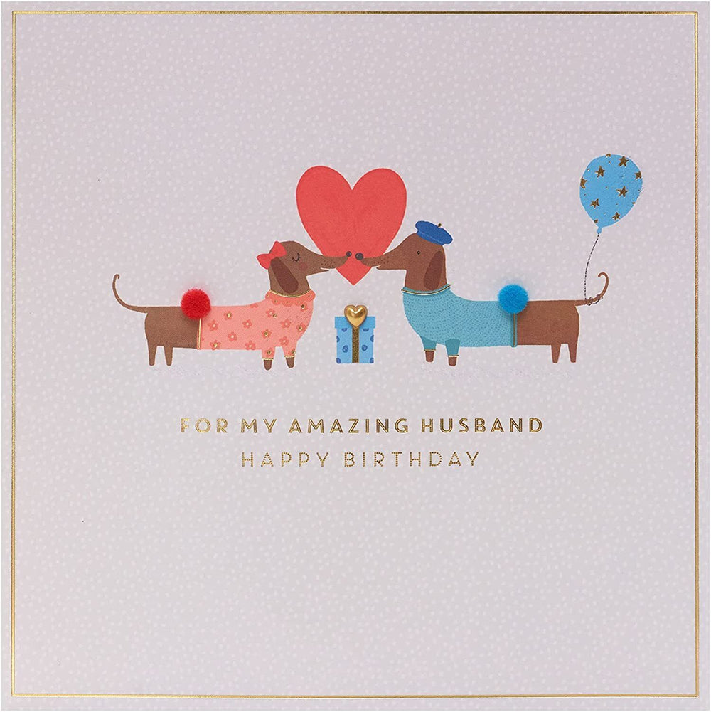 UK Greetings cute sausage dog design husband birthday card, featuring playful dog illustration on a cheerful greeting card.