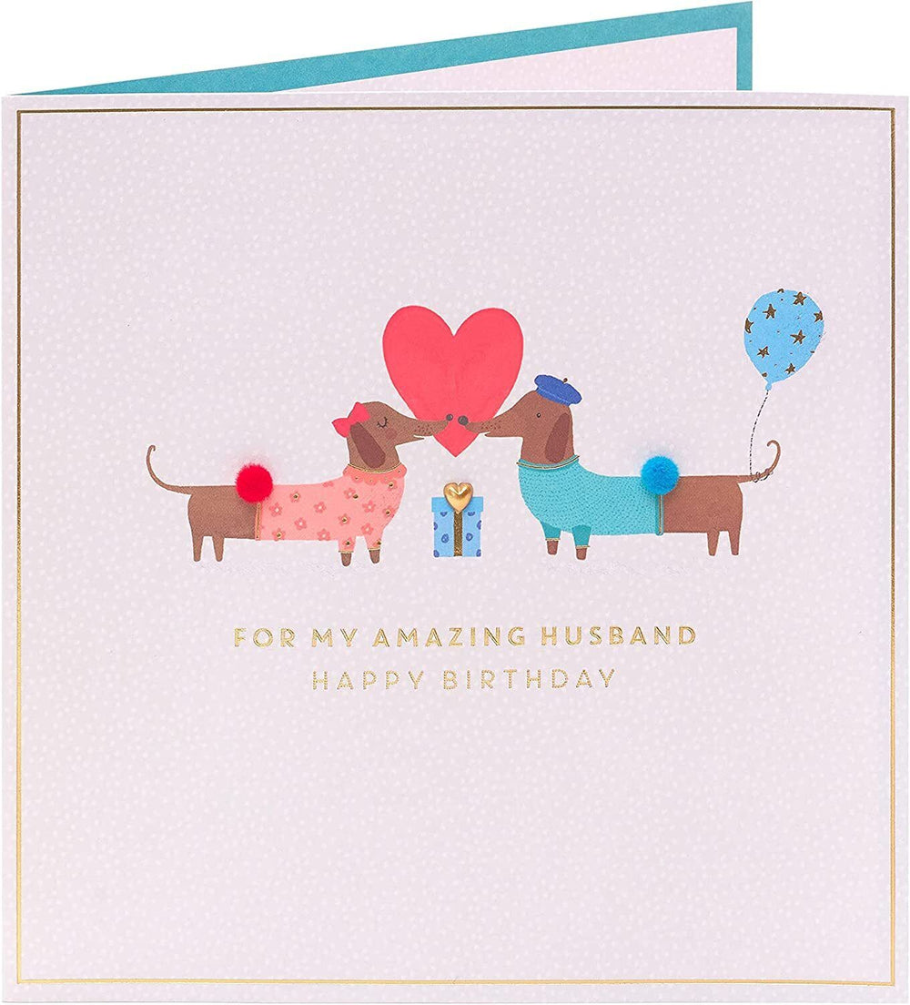 UK Greetings cute sausage dog design birthday card for husband, featuring playful dog illustration on greeting card.