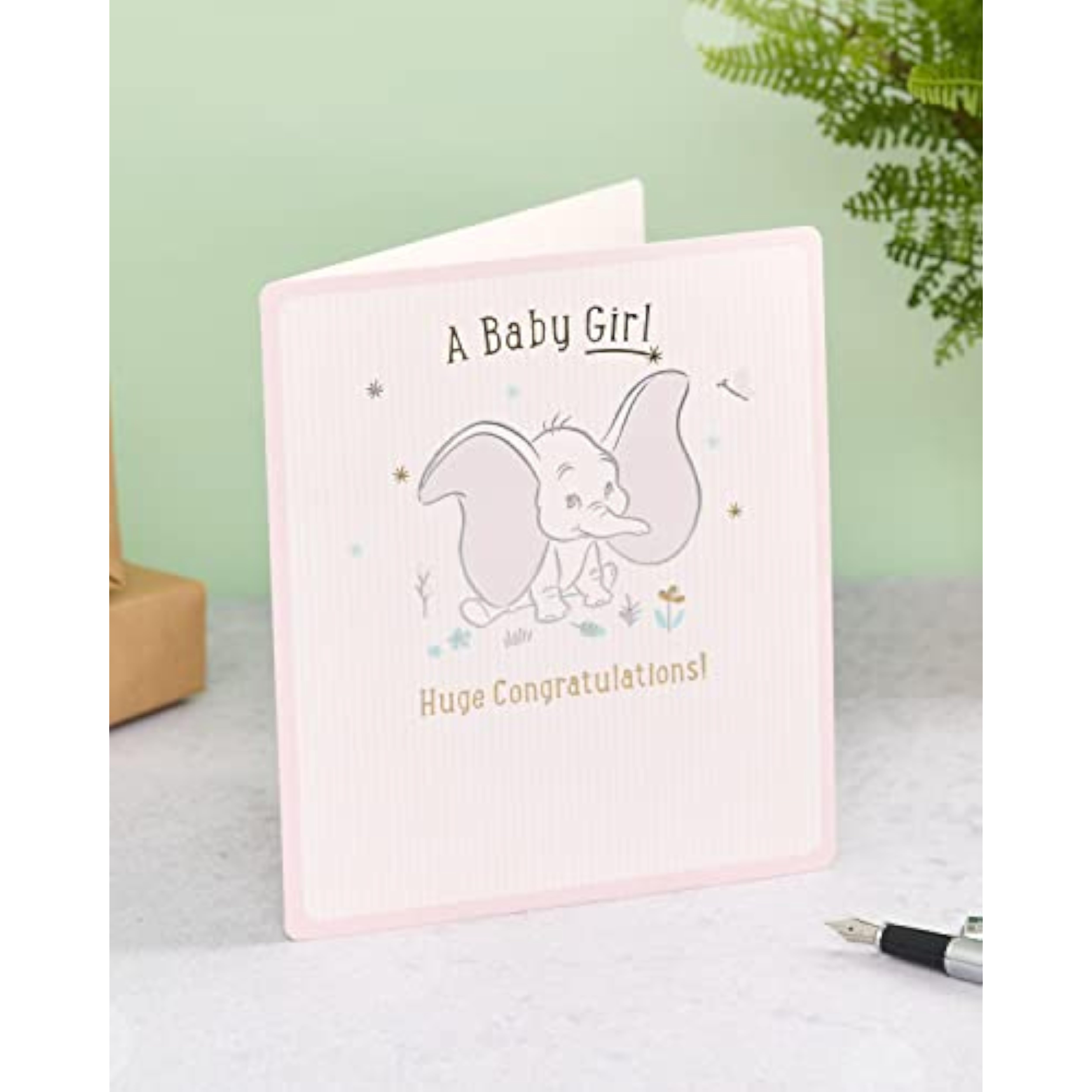 Disney Dumbo baby girl congratulations greeting card by UK Greetings featuring colorful Dumbo illustration and cheerful design.
