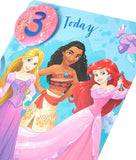 UK Greetings Disney Princesses 3rd Birthday greeting card with badge featuring colorful princess illustrations and festive design.