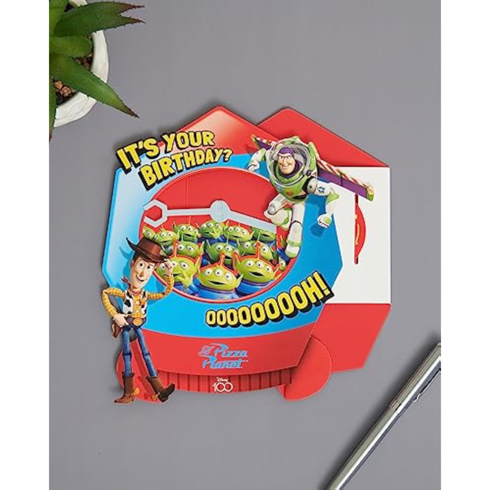 UK Greetings Toy Story greeting card featuring Woody and Buzz Lightyear with a grabber machine design, perfect for birthdays.