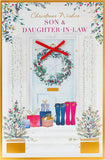 UK Greetings Christmas card featuring a doorway with wreath design for son and daughter-in-law, festive holiday greeting card image.