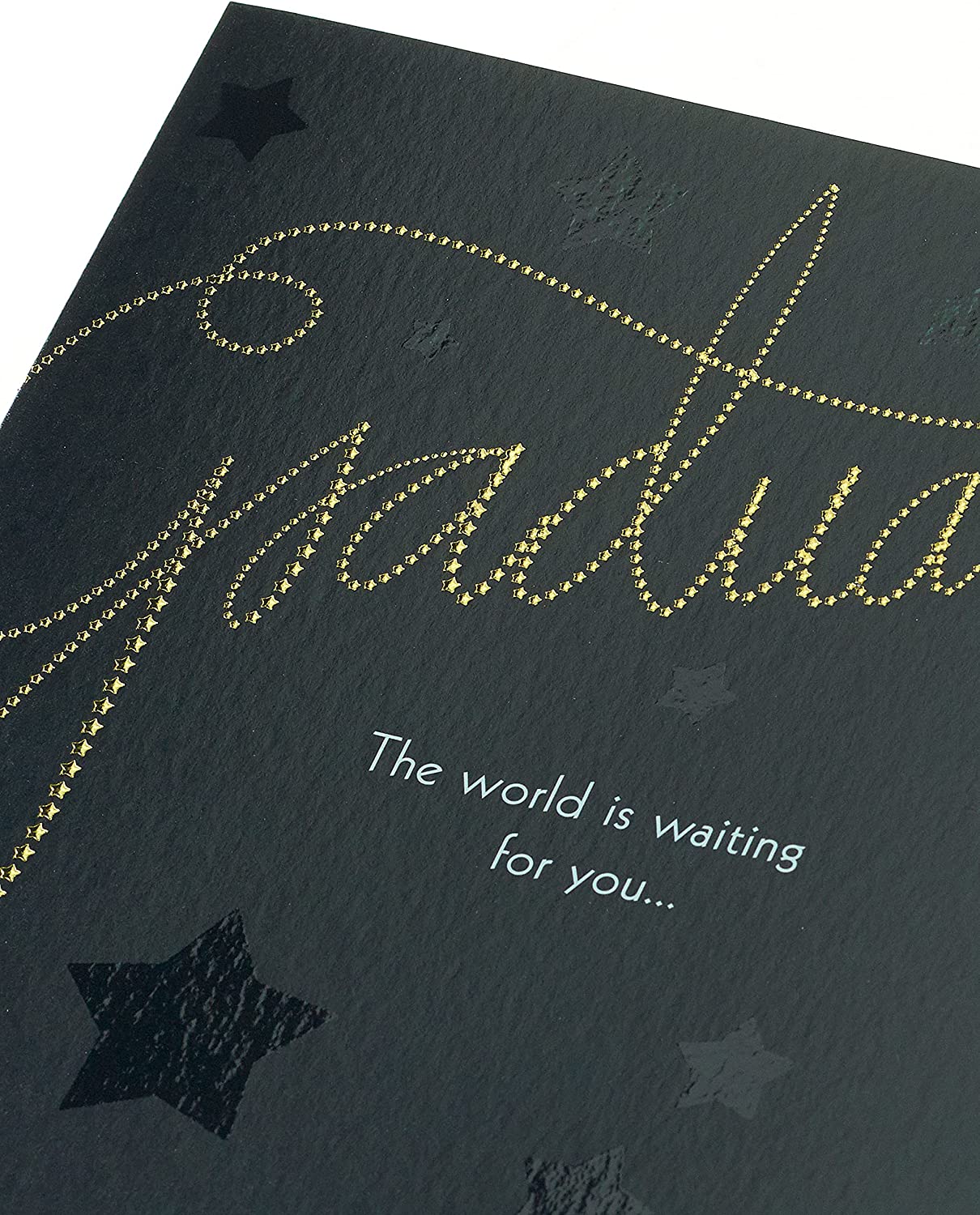 UK Greetings elegant graduation card with foil and embossed finish, featuring a celebratory design on the front.