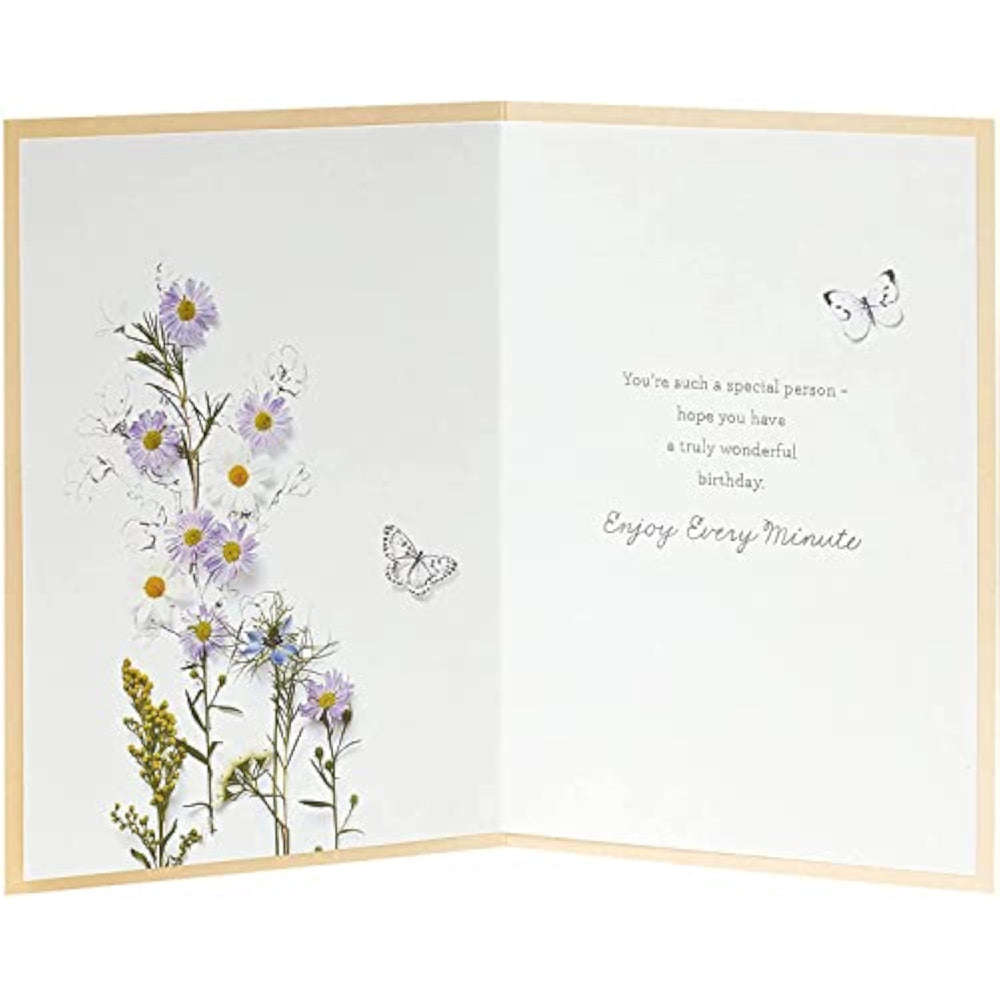 UK Greetings embossed birthday card featuring a cute floral design from the Into the Meadow range, with colorful flowers and embossed details.