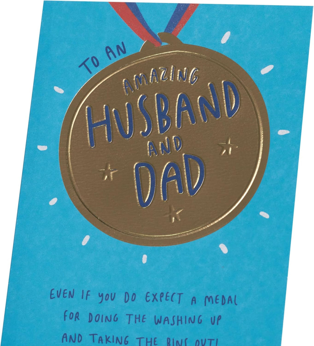 UK Greetings Father's Day card for husband or dad featuring a gold medal design and heartfelt message, ideal for celebrating dads.
