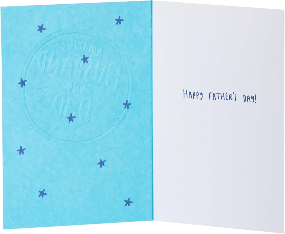 UK Greetings Father’s Day card for husband or dad featuring a gold medal design, with colorful and celebratory graphics.