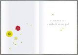 UK Greetings floral cake design birthday wishes card with colorful meadow flowers and cheerful message, perfect for celebrating.