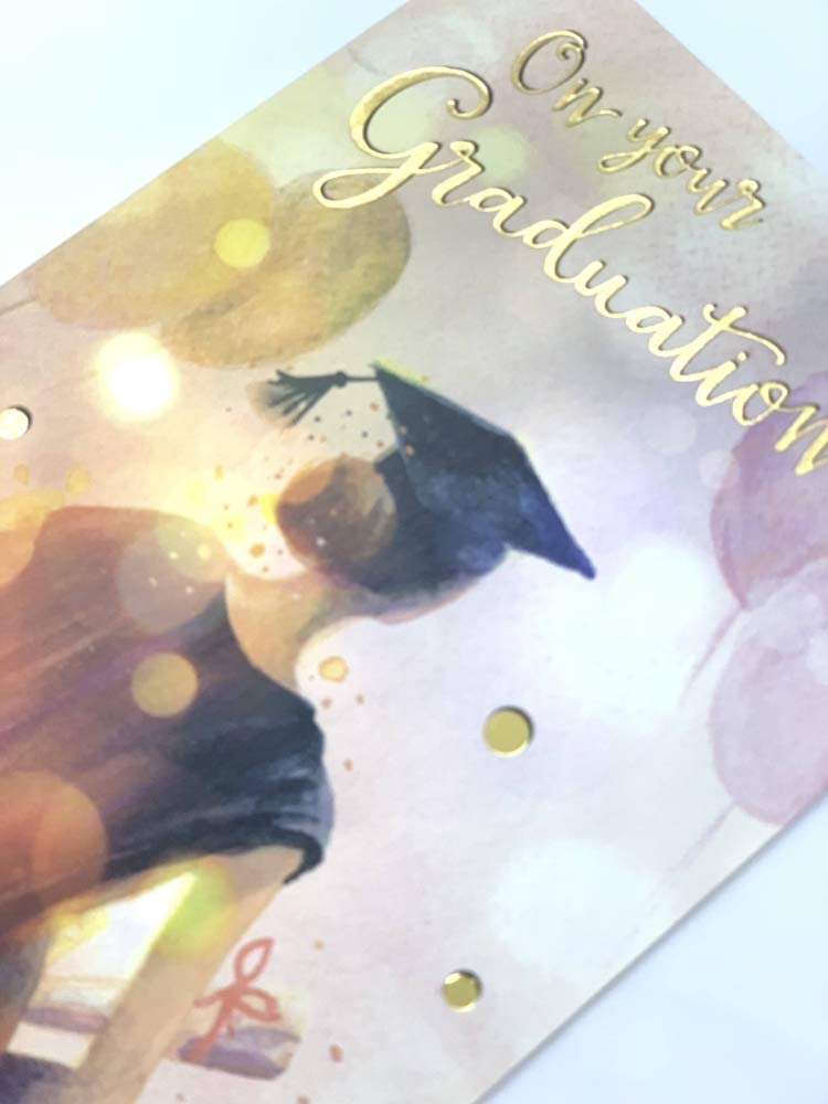 UK Greetings graduation card featuring a girl with balloons, celebrating a graduation with colorful, festive imagery.