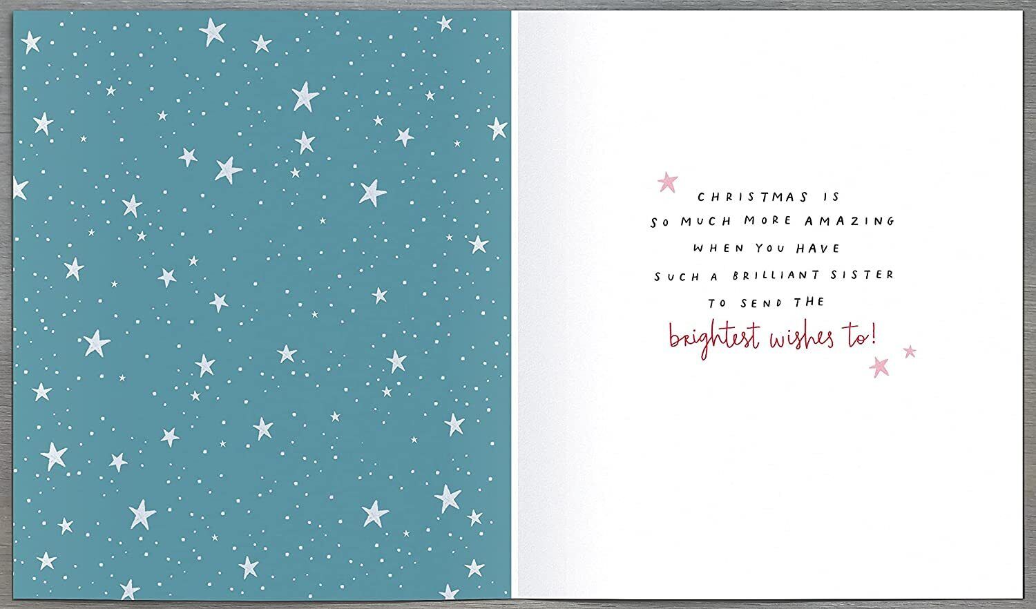 UK Greetings jumper design Christmas card for sister, featuring festive holiday imagery and heartfelt greeting on a greeting card.