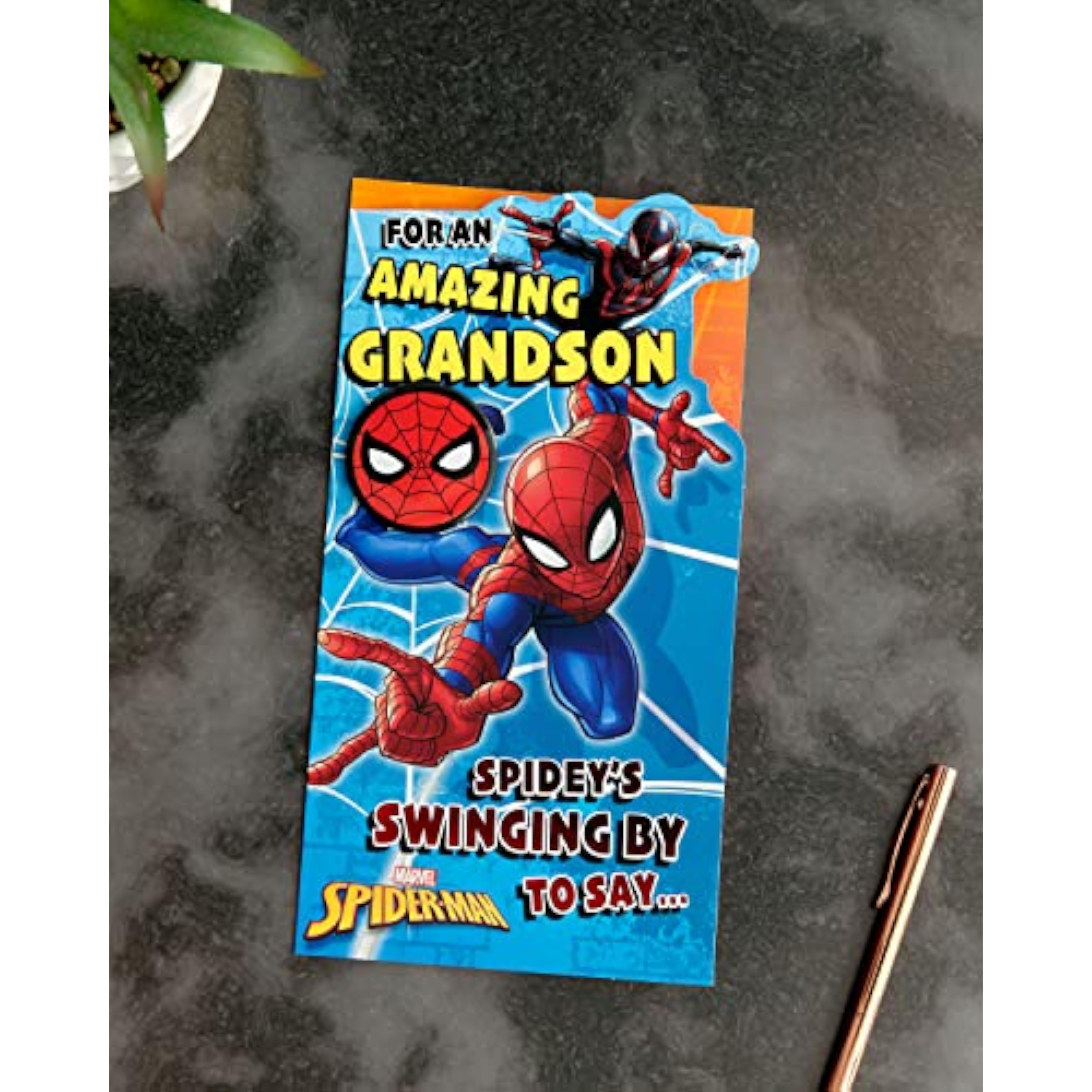Marvel Spider-Man birthday greeting card for grandson by UK Greetings, includes envelope and badge, colorful and festive design.