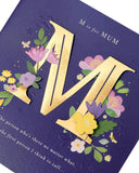 UK Greetings Mother's Day card with envelope, dark blue bold letter design, 210x210mm, featuring a stylish greeting card image.