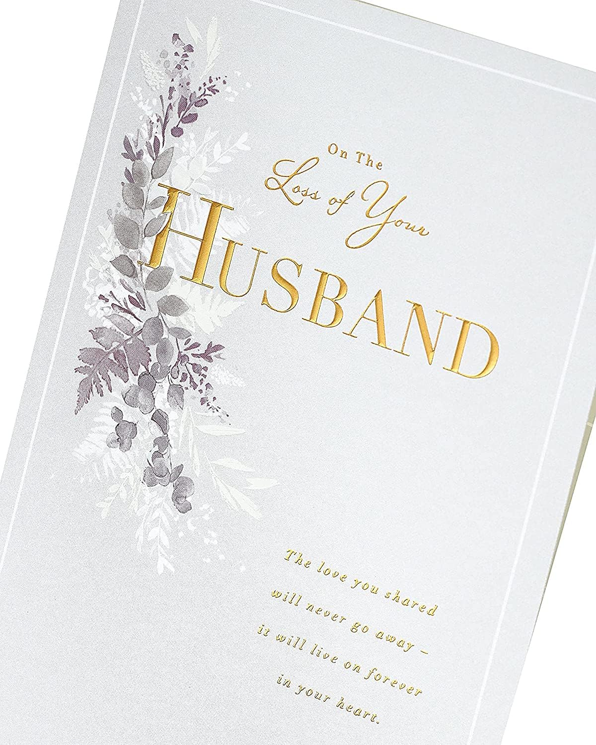 UK Greetings sympathy card with gold foil details expressing condolences on the loss of a husband, featuring heartfelt design.
