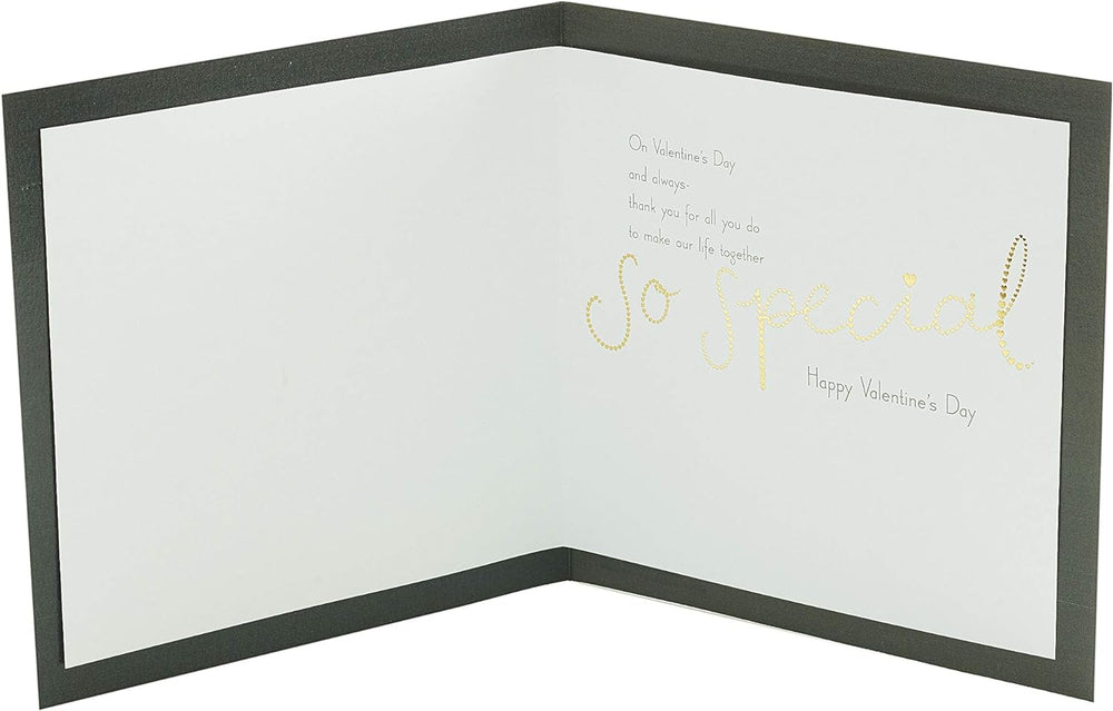 UK Greetings Valentine’s Day partner card for him or her with dark and gold design and envelope, suitable for celebrating love.