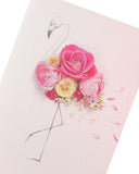 Pink floral flamingo birthday greeting card by UK Greetings featuring vibrant floral design and a cheerful flamingo illustration.