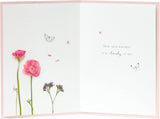 Pink floral flamingo birthday card by UK Greetings, featuring vibrant floral designs and a playful flamingo illustration.