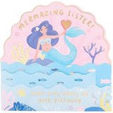 UK Greetings pop-up mermaid sister birthday card featuring colorful underwater scene and intricate 3D design.