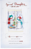 UK Greetings Christmas card featuring snowmen decorating a tree, with a daughter and son-in-law in festive holiday scene.