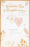 UK Greetings anniversary greeting card featuring gold and pearl hearts for son and daughter-in-law, traditional design.